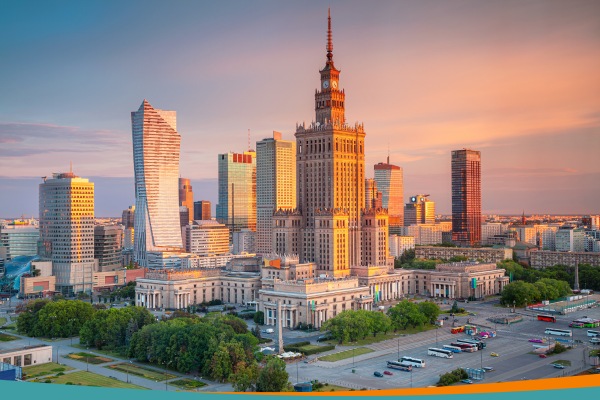 Warsaw skyline at sunset with the Palace of Culture and Science in the centre surrounded by modern skyscrapers